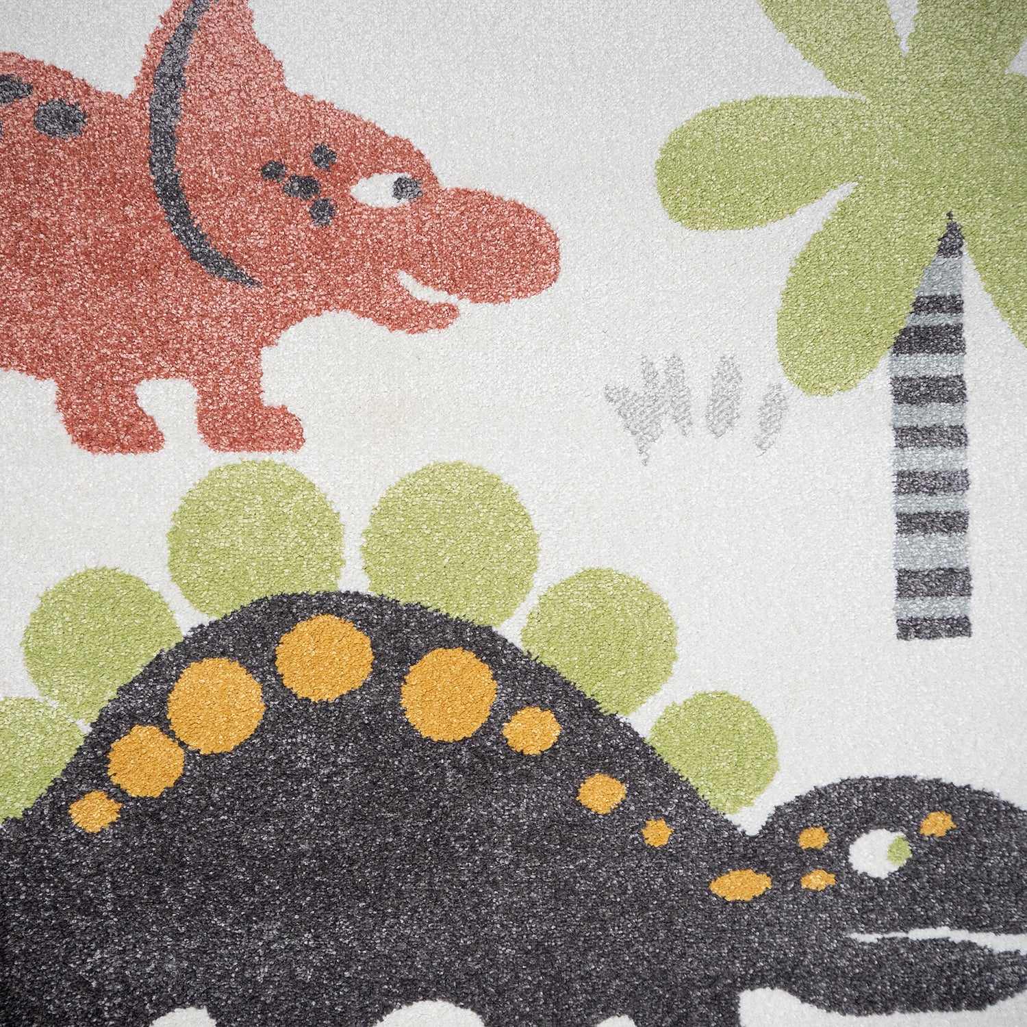 Valkoinen Dinokaverit-matto värikkäillä dinoilla.