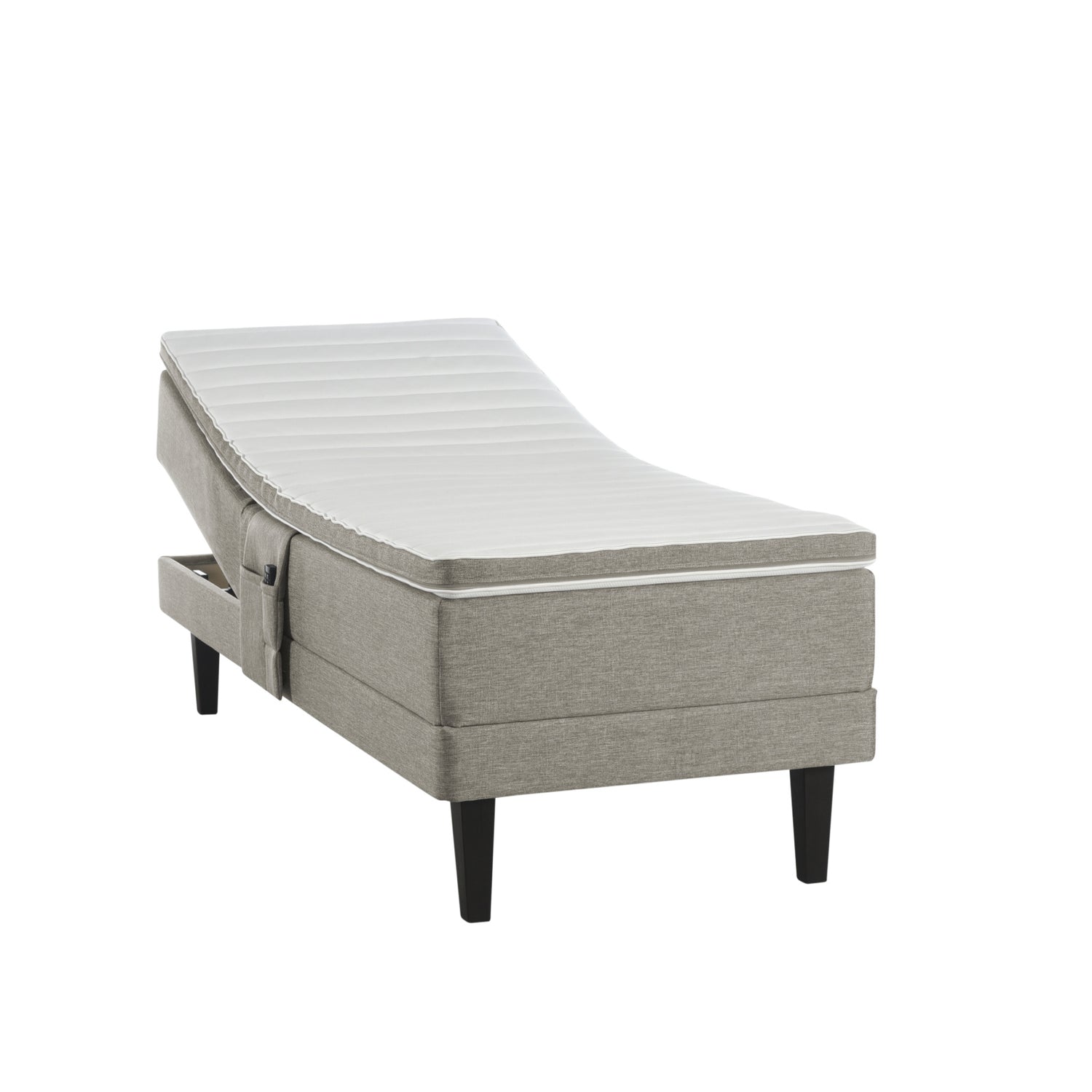 Hiekanvärinen Havu-moottorisänky wengen värisillä Royal-jaloilla ja profiloidulla sijauspatjalla. Kuvan tarviketasku myydään erikseen.