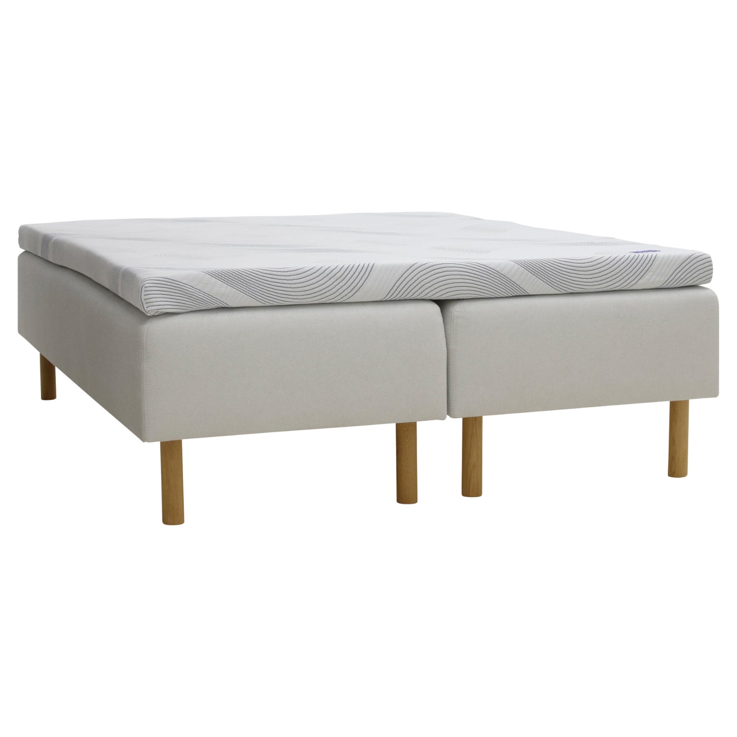 Kuvassa on beige Tunnel 01 -kangasverhoiltu Heaven By Unico Revive -runkosänkypaketti. Pakettiin kuuluu 2 kpl Revive-runkopatjaa ja yhtenäinen Revive 8 Nano Cool™-verhoiltu Memory -ergosijauspatjaa sekä pyöreät tammenväriset puujalat.