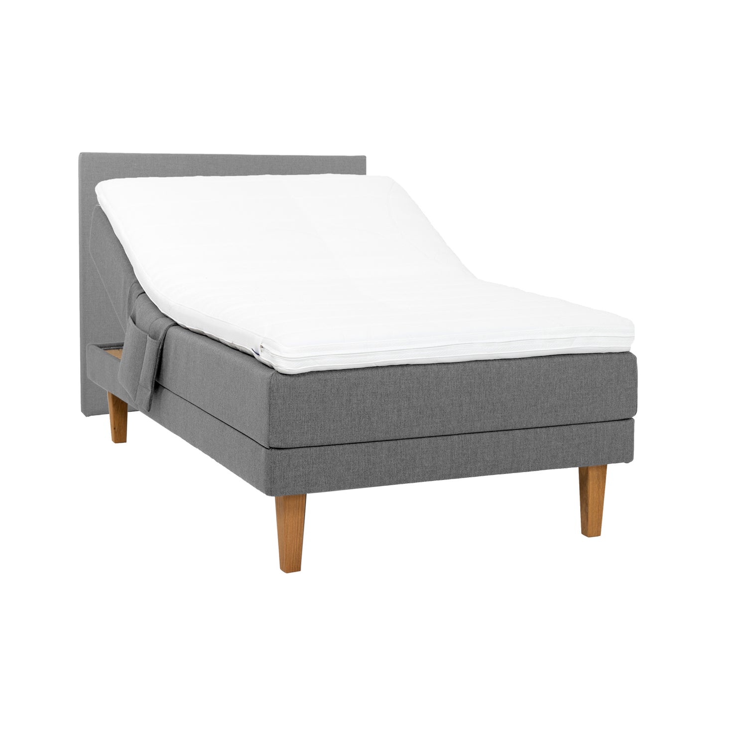 Harmaa Hilding Feel -moottorisänky 120 x 200 cm luonnonvärisillä 23 cm korkeilla Royal -tammijaloilla ja Hilding Hybrix Air Coolmax -sijauspatjalla. Kuvan sängynpääty ja tarviketasku myydään erikseen.
