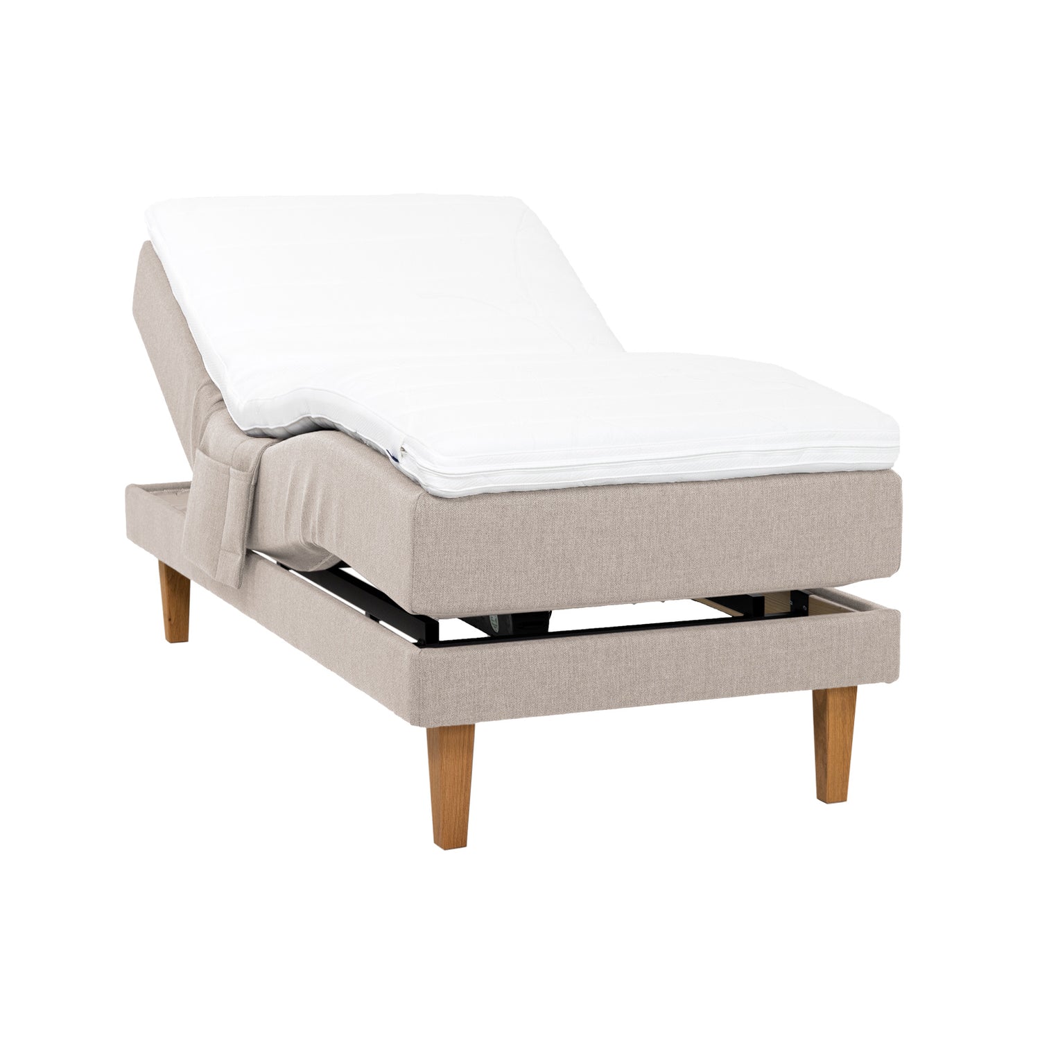 Beige Hilding Original -moottorisänky luonnonvärisillä 23 cm korkeilla Royal -tammijaloilla ja profiloidulla kimmovaahtosijauspatjalla. Kuvan tarviketasku myydään erikseen.