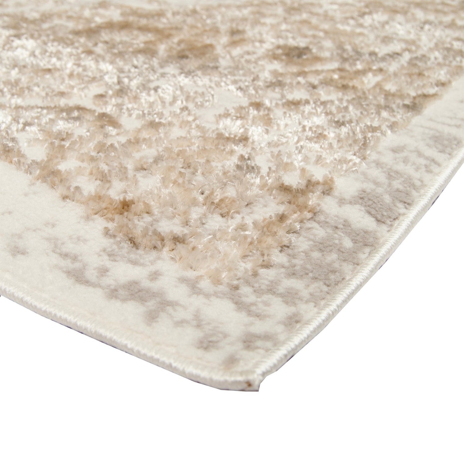 Lähikuvassa on Luna-nukkamaton valkoisen-beigeä pintaa, jossa on eripituiset nukat muodostamassa itämaisen kuosin.