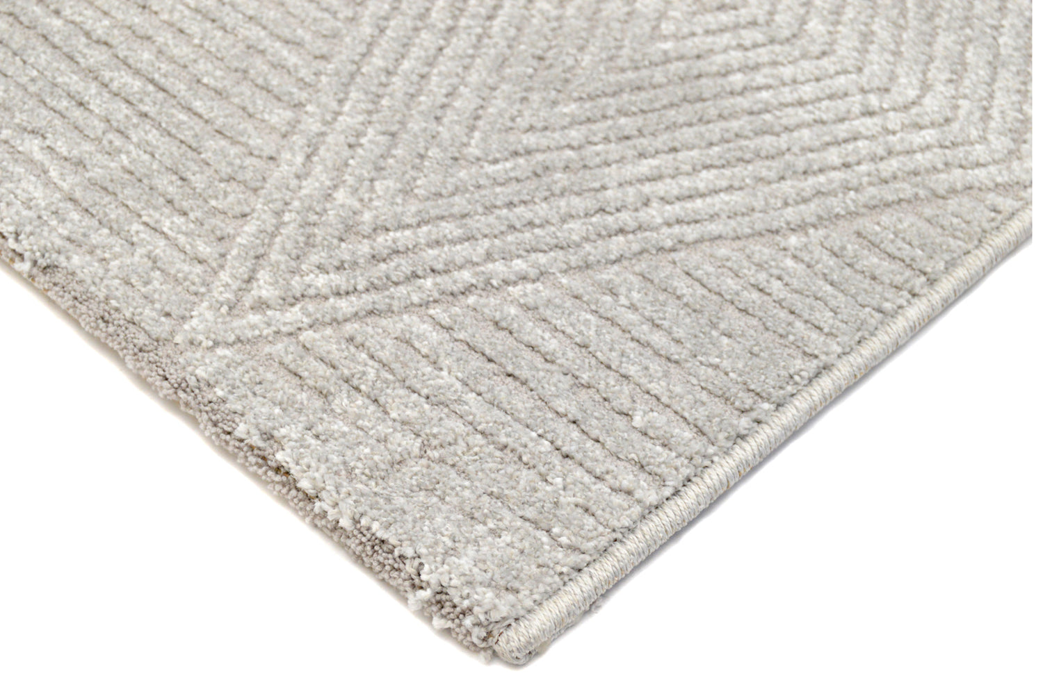 Lähikuvassa vaaleanharmaan Felicia-nukkamaton kuvioitua pintaa.