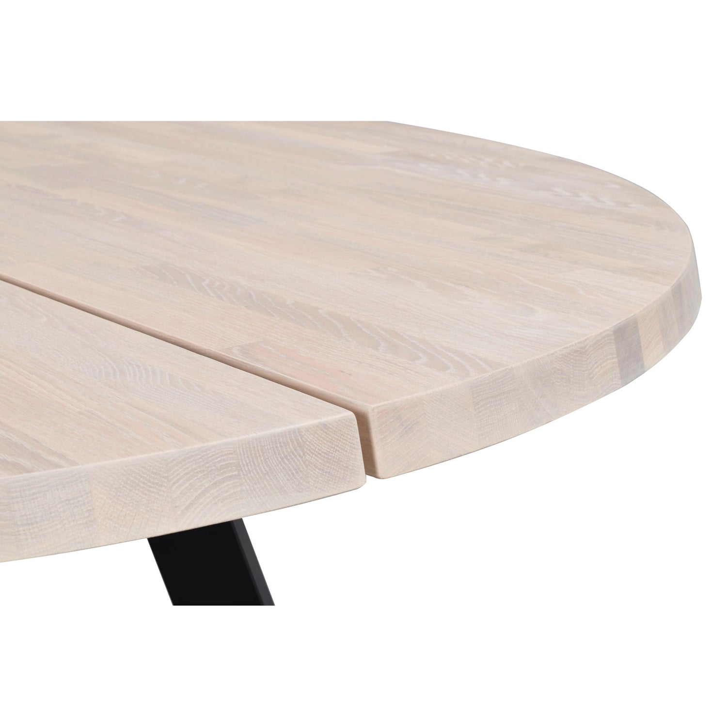 Lähikuvassa valkotammenvärisen pyöreän Fred-ruokapöydän pinta. Pöydässä on mustat metallijalat.