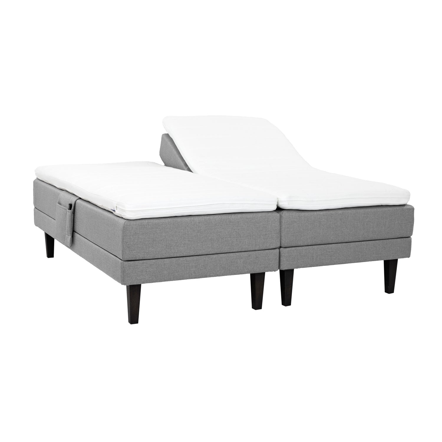 Harmaat Hilding Feel Ergo -moottorisängyt 90 x 200 cm hiilenmustilla 23 cm korkeilla Royal -tammijaloilla ja erillisillä Hilding Ergo -sijauspatjoilla. Kuvan tarviketasku myydään erikseen.