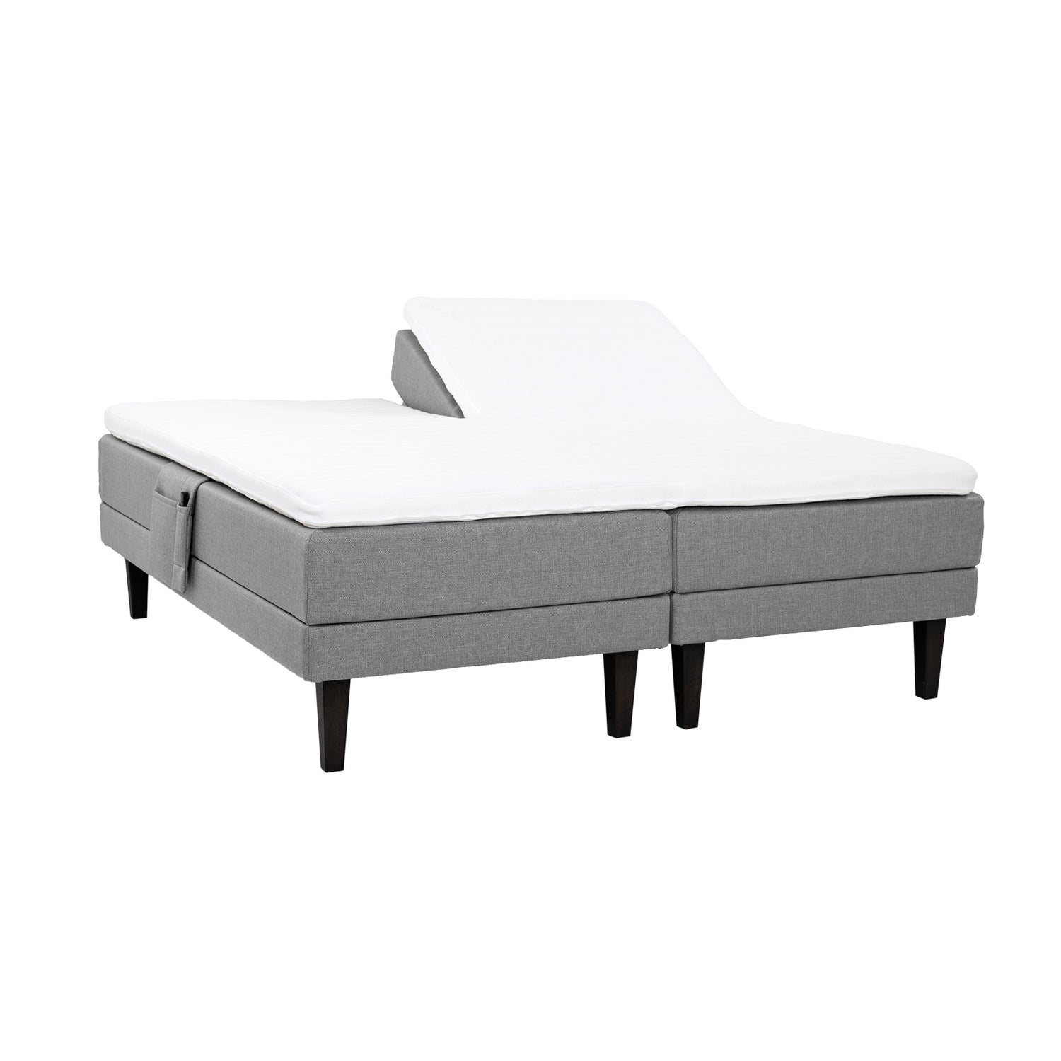 Harmaat Hilding Feel -moottorisängyt hiilenmustilla 23 cm korkeilla Royal -tammijaloilla ja yhtenäisellä osittain halkaistulla 160 x 200 cm Hybrix Air Coolmax Split -sijauspatjalla. Kuvan tarviketasku myydään erikseen.