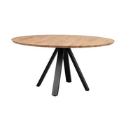 Pyöreä Carradale-ruokapöytä tammenvärisellä kannella ja mustilla V-mallisilla metallijaloilla.