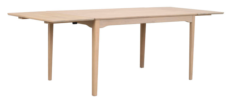 Kuvassa on valkotammenvärinen Markham-ruokapöytä 140 x 90 cm, joka on jatkettu molemmista päistä 45 cm jatkopaloilla 230 cm mittaan.