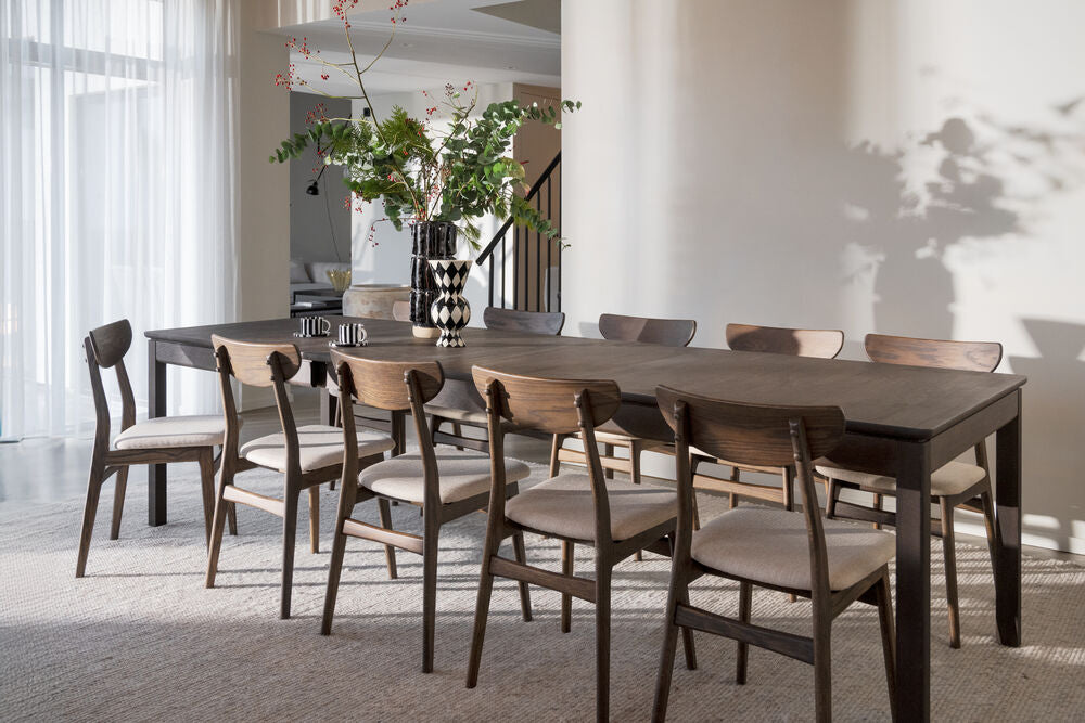 Kuvassa on ruskea Gardner-ruokapöytä erikseen myytävien Rowicon Rodham-tuolien kanssa.