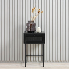 Kuvassa on Pensacola-yöpöytä/sivutaso musta. Pensacola-yöpöytä/sivutaso musta. Pikkutason laatikon
etulevyssä on yksityiskohtana polyrottinki. Mustat metallijalat.