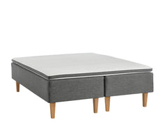 Antrasiitin värinen Aava-runkopatjasänky luonnonvärisillä Royal-tammijaloilla ja yhtenäisellä profiloidulla sijauspatjalla.