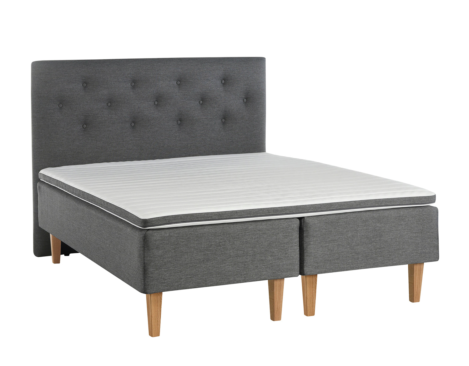 Antrasiitin värinen Aava-runkopatjasänky luonnonvärisillä Royal-tammijaloilla ja yhtenäisellä profiloidulla sijauspatjalla. Kuvan sängynpääty myydään erikseen.