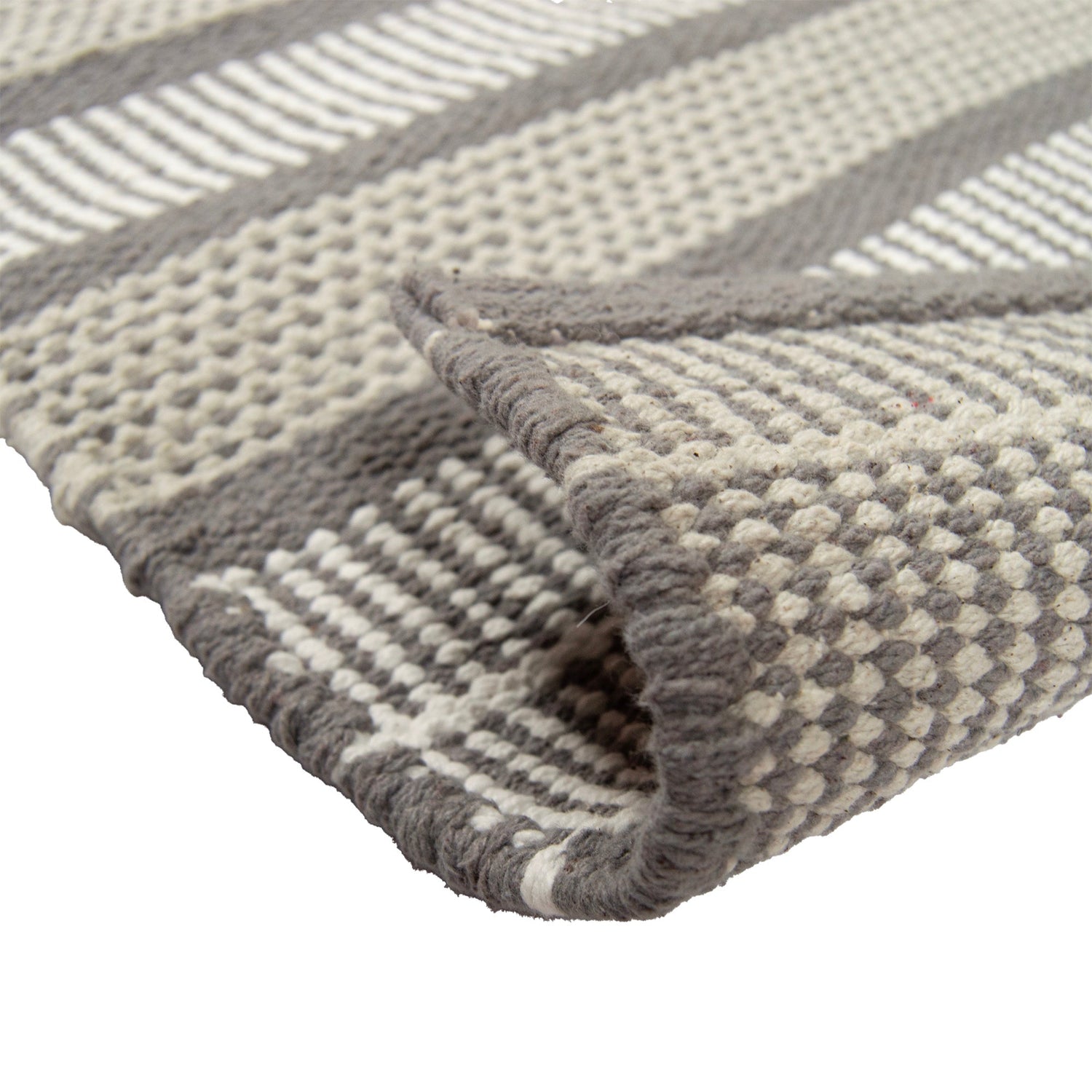 Lähikuvassa Foksi-puuvillamaton harmaan sävyistä pintaa.