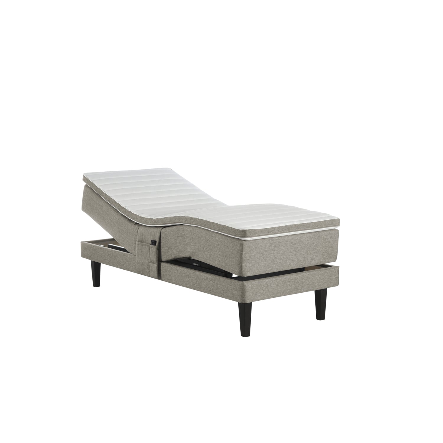 Hiekanvärinen Havu-moottorisänky wengen värisillä Royal-jaloilla ja profiloidulla sijauspatjalla. Kuvan tarviketasku myydään erikseen.