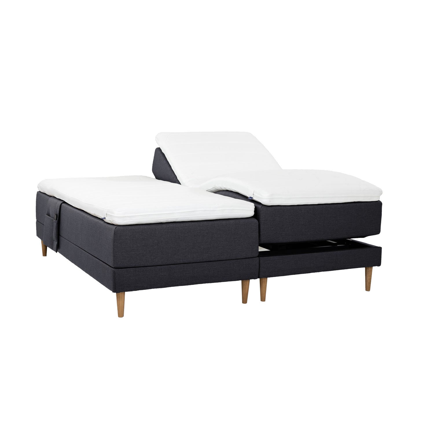 Antrasiitinväriset Hilding Cross -moottorisängyt tammenvärisillä Hilding Raita -tammijaloilla, erillisillä Hilding Ergo -sijauspatjoilla ja Hilding -tarviketaskulla.