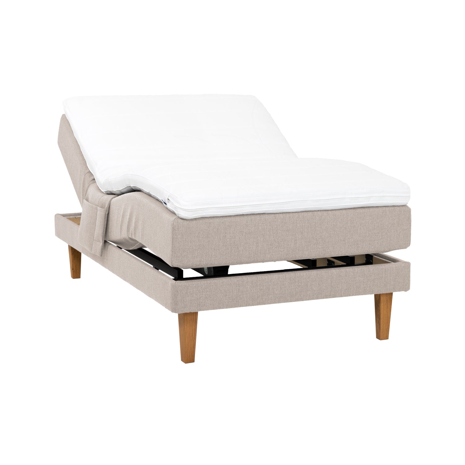Beige Hilding Original -moottorisänky luonnonvärisillä 23 cm korkeilla Royal -tammijaloilla ja profiloidulla kimmovaahtosijauspatjalla. Kuvan tarviketasku myydään erikseen.