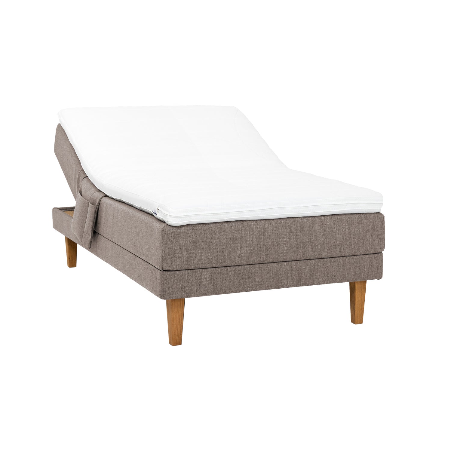 Hiekanvärinen Hilding Feel -moottorisänky 120 x 200 cm luonnonvärisillä 23 cm korkeilla Royal -tammijaloilla ja Hilding Hybrix Air Coolmax -sijauspatjalla. Kuvan tarviketasku myydään erikseen.