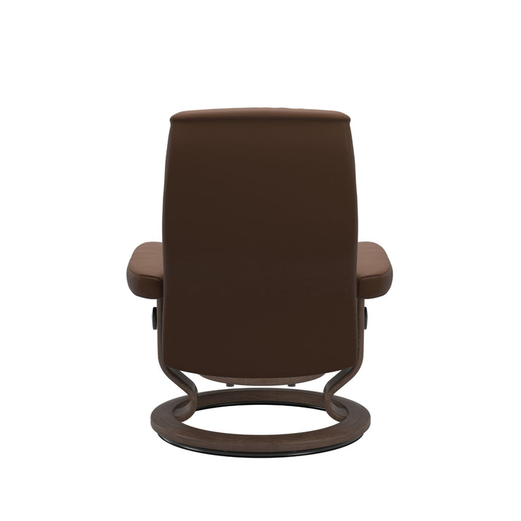 Stressless Opal M -lepotuoli ja rahi ruskeana: Warm Brown 87 Batick-nahkaverhoilulla ja pähkinä petsatulla -Classic-puujalustalla.