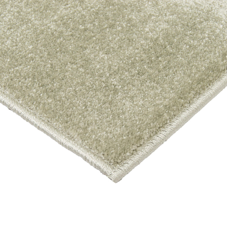 Kuvassa näkyy vaaleanvihreän Seepra-kuvioisen maton kulmaa ja lankakanttausta.