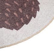 Kuvassa beigen ja ruskean sävytteisen Siilinen-lastenmaton reunausta.