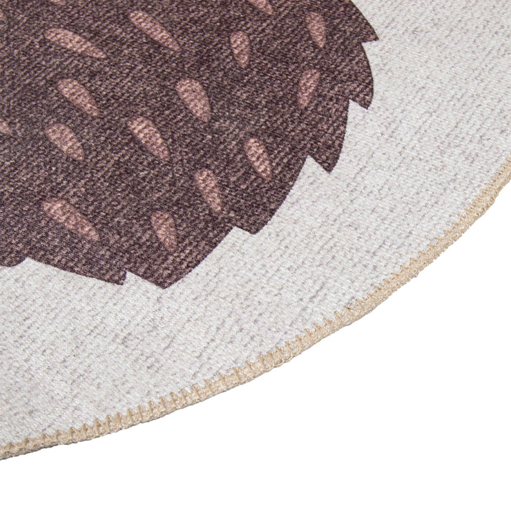 Kuvassa beigen ja ruskean sävytteisen Siilinen-lastenmaton reunausta.