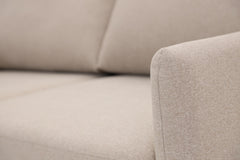 Lähikuvassa Stockholm Max Hybrid Deluxe 2-istuttava-vuodesohva beigellä Oasis 02 -kankaalla.