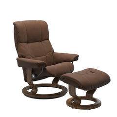 Stressless Mayfair M -lepotuoli ja rahi ruskeana: Warm Brown 87 Batick-nahkaverhoilulla ja tiikki petsatulla -Classic-puujalustalla.