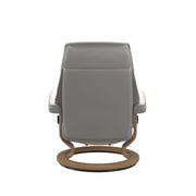 Stressless Ruby M -lepotuoli ja rahi valkoisena: Milky White 05 Batick-nahkaverhoilulla ja tammi petsatulla -Classic-puujalustalla.