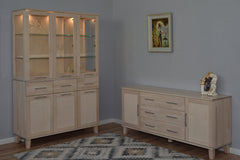 Kuvassa on valkolakattu Vuokatti-vitriini. Vitriinissä on lasikaapisto lasihyllyillä, alaosan tilava senkki kaappien peiliovilla, sekä pitkänmalliset RST-vetimet. Lasikaapin sisällä olevat valot/viinilasit eivät kuulu senkin hintaan. Kuvassa on lisäksi Vuokatti-sarjan senkki 24/1.