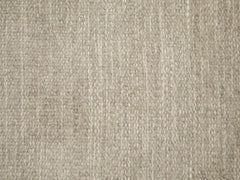 Lähikuva Emma-villamaton harmaasta pinnasta, joka on tiivis, likaa hylkivä ja helppo pitää puhtaana.