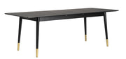 Fenwood-ruokapöytä on musta ja sen sorvatuissa jaloissa on kullanväriset metalliyksityiskohdat. Pöydän mukana on kaksi jatkopalaa, joilla pöytää voi jatkaa. Kuvassa pöytä on 220 cm, jatkettuna yhdellä jatkopalalla.