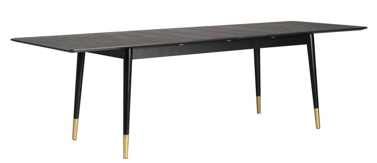 Fenwood-ruokapöytä on musta ja sen sorvatuissa jaloissa on kullanväriset metalliyksityiskohdat. Pöydän mukana on kaksi jatkopalaa, joilla pöytää voi jatkaa. Kuvassa pöytä on 260 cm, jatkettuna kahdella jatkopalalla.