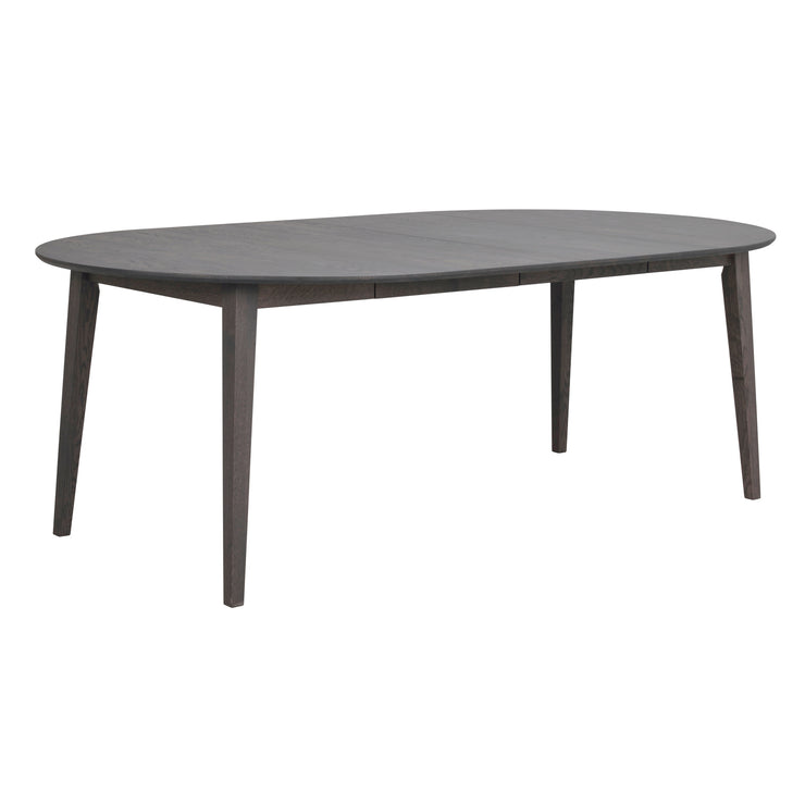 Pyöreä Filippa-ruokapöytä savutammenvärisenä. Kuvan pöytä on jatkettuna kahdella jatkolevyllä, jolloin pöydän pituus on 210 cm. Pöydän mukana tulee yksi jatkolevy ja toinen on saatavana erikseen myytävänä.