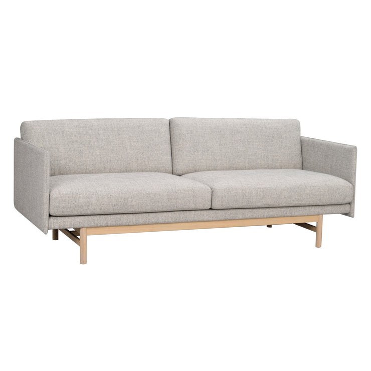 Hammond 3-istuttava sohva harmaalla kangasverhoilulla ja valkotammenvärisellä jalkaosalla.