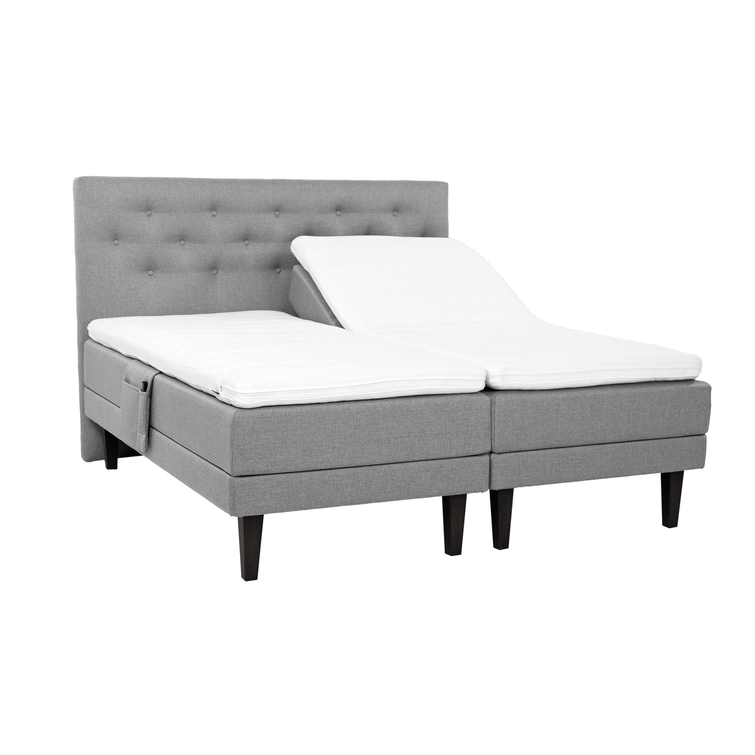 Harmaat Hilding Feel -moottorisängyt hiilenmustilla 23 cm korkeilla Royal -tammijaloilla ja erillisillä Hilding Hybrix Air Coolmax -sijauspatjoilla. Kuvan Feel -sängynpääty ja tarviketasku myydään erikseen.
