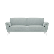 Ilona 2 - 3 istuttava sohva jäänharmaan/mintun värisellä AC Naomi 347 -kankaalla ja valkoisilla 18 cm korkeilla vinoilla pyöreäkartiojaloilla.  Kuvan sohvassa on 17 cm leveät KNT-käsinojat.