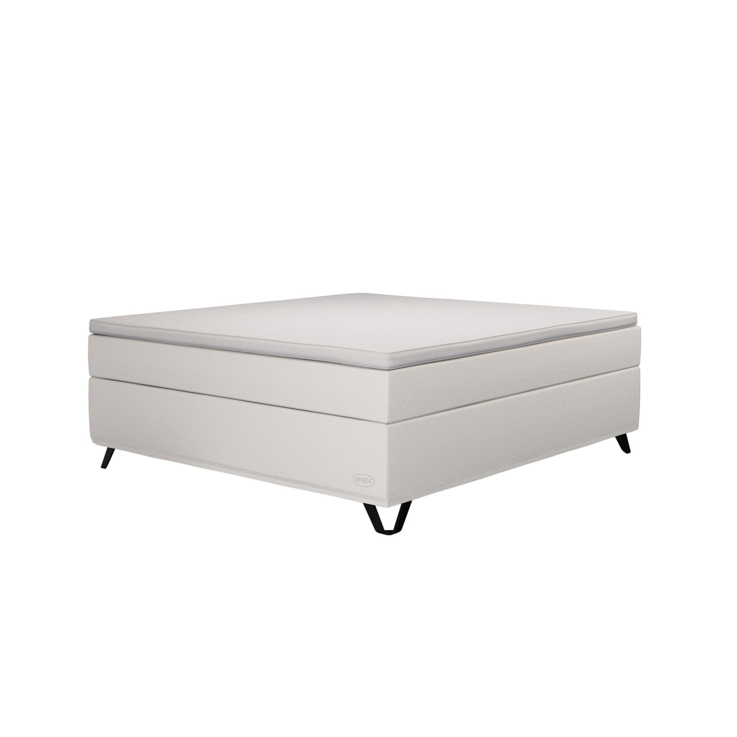  Jensen Carat -jenkkisängyn beige verhoiluväri ja 14 cm korkeat mustat kolmiojalat. TempSmart-sijauspatja ja jalat sisältyvät hintaan.